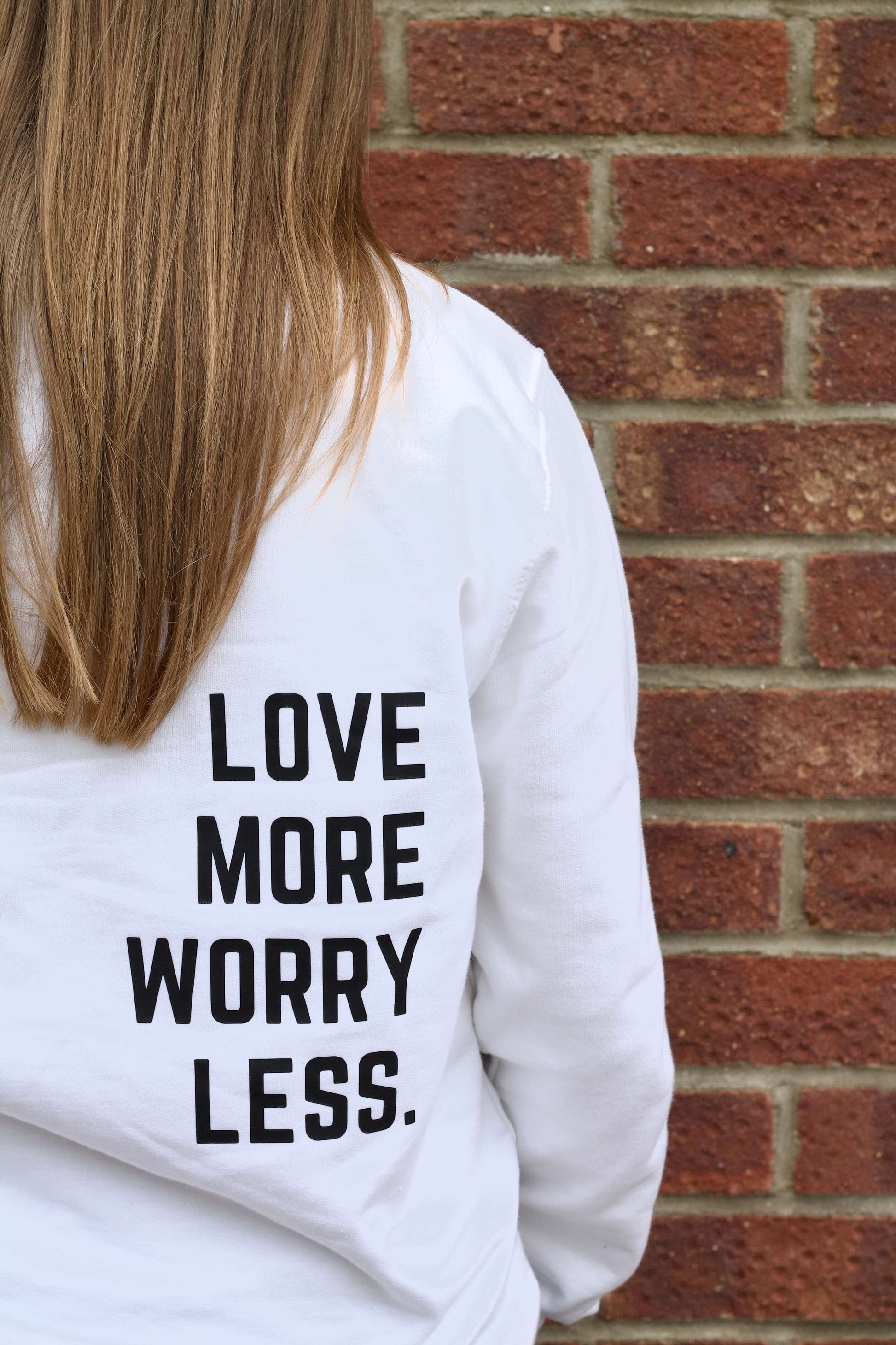 White crew neck sweater with Love more worry less design